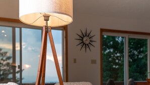 A cozy living room with a wooden rocking chair, a floor lamp, and a large window offering a view of the outdoors. - Gorgeous mountain view - 3 minutes from Downtown Asheville (Asheville)