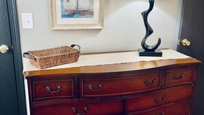 A wooden dresser with drawers, a lamp, and a framed picture on the wall. - Deer Ridge Duplex - Beautiful Lake View with Shared Dock! (Sunrise Beach)
