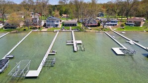 A residential area with houses, a dock, and a grassy area.