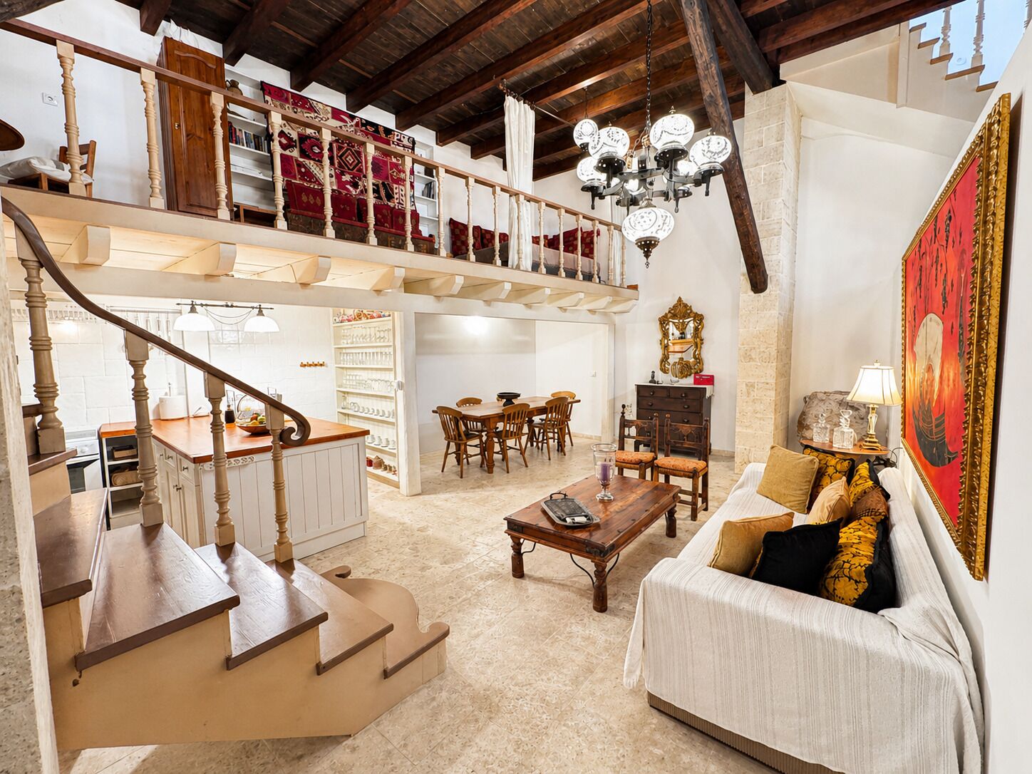 A spacious living area with a staircase, a dining area, and a cozy seating area.