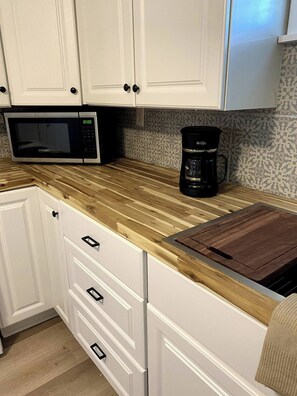 Fridge, cookware/dishes/utensils, dining tables - Tiny Home In Pensacola , Near Baptist Hospital/HCA/Ascension Sacred/& PCC (Pensacola)