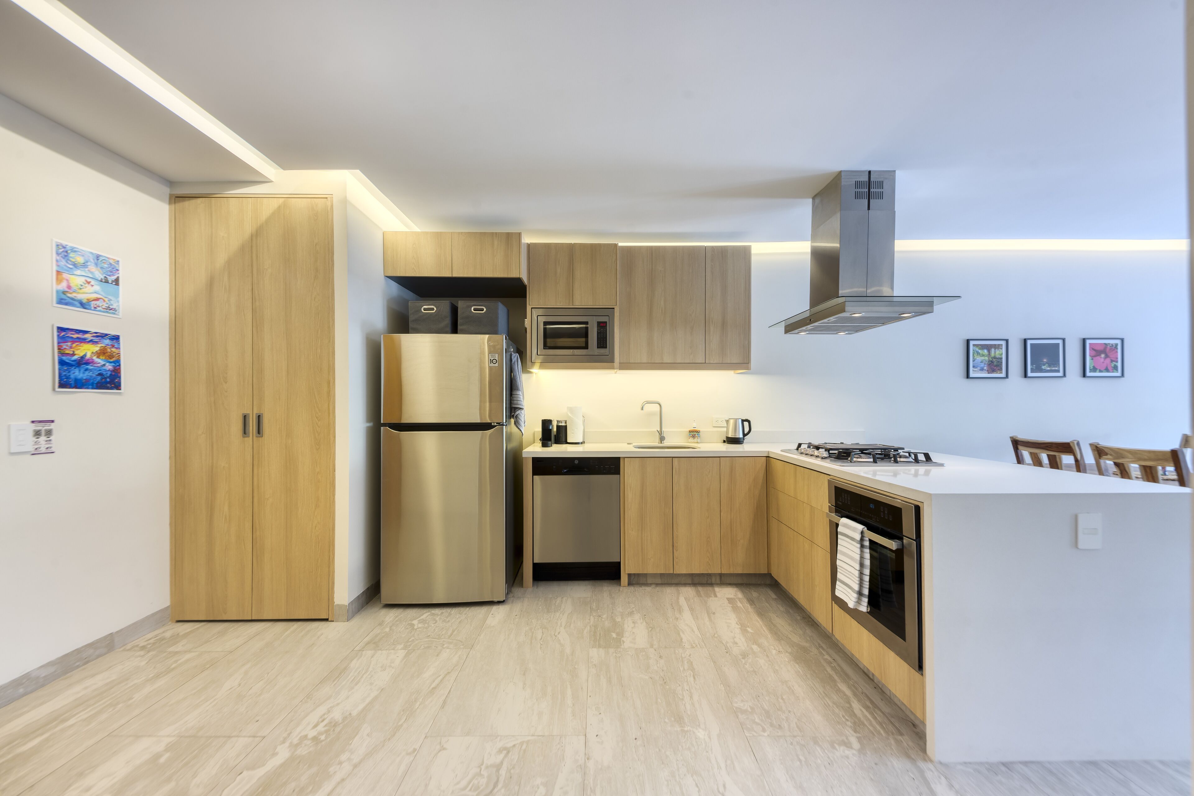 A modern kitchen with wooden cabinets, stainless steel appliances, and a central island.