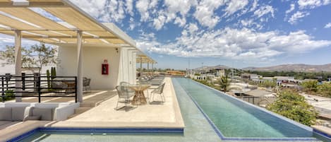 Outdoor pool, open 9:00 AM to 10:00 PM, pool umbrellas, sun loungers