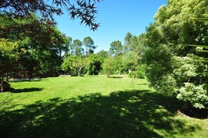 Enjoy a serene natural environment surrounded by lush trees and shrubs in our beautifully maintained garden.