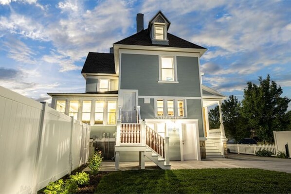 Stunning two-story home with a charming front porch and beautifully manicured lawn.