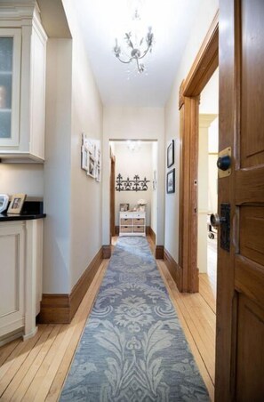 Enter a beautifully appointed room with a door on the right, featuring a window and a wooden door.
