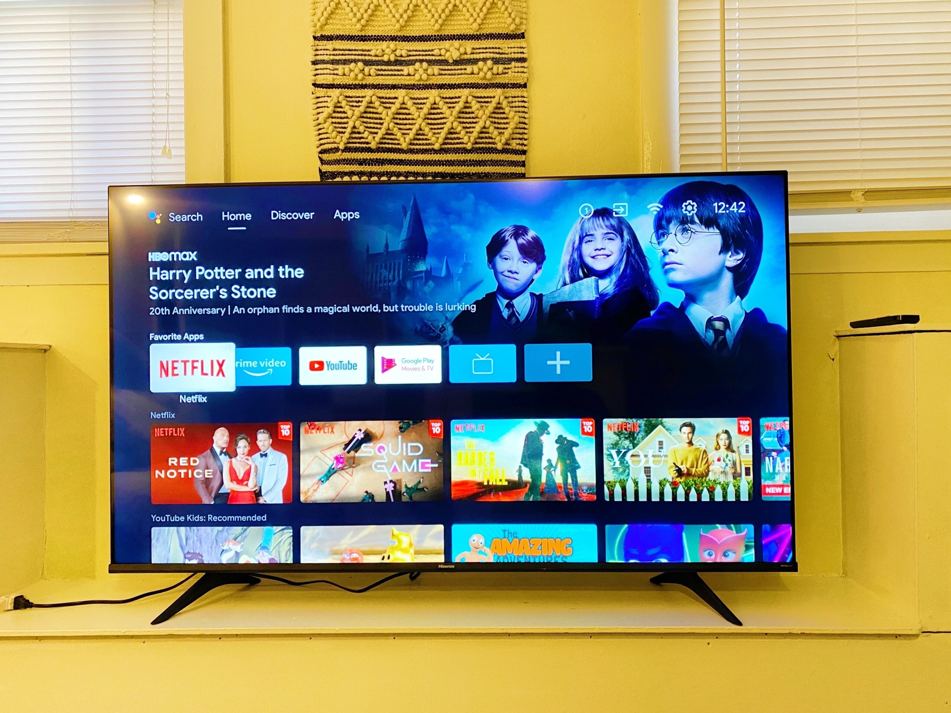 A television displaying a streaming service interface with various content options and a highlighted movie title.