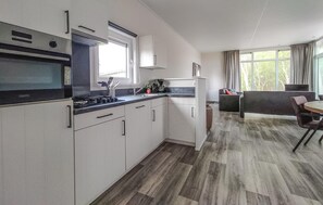 Enjoy meals in the kitchen with a dining area and table.