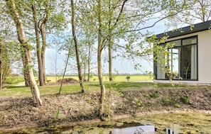Situated in a serene natural setting, this building features clean lines and a neutral palette, blending seamlessly with the surrounding landscape.