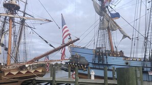A historic ship docked at a pier with a lifebuoy and a small lighthouse structure. - Oyster Cottage  - walk to shops , Mainstay music venue and the Bay! (Rock Hall)