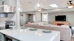 A modern kitchen with a central island, built-in appliances, and pendant lighting. - Beautiful 3 bedroom 2 bathroom waterfront home on Drs. Lake (Orange Park)