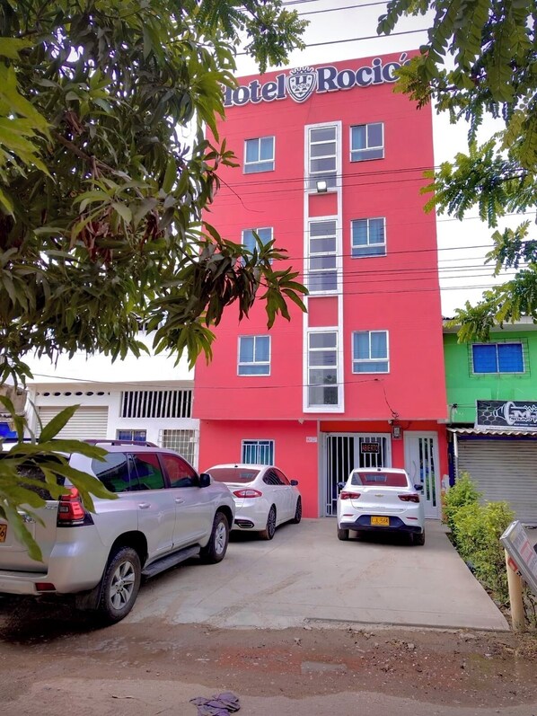 A red building with a sign reading "Hotel Rocio." - Hotel Rocios (Soledad)