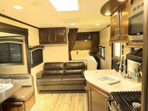 Enjoy a compact, well-appointed space with a kitchenette, sofa, and view.