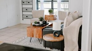 A modern kitchen with a black stove, wooden cabinets, and a ceiling fan. - Perfect Family Vacation House (Pace)