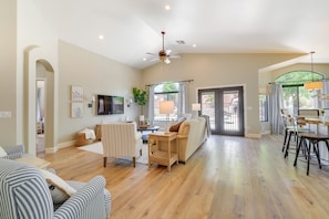 Relax in this open living area with a sofa set, dining table, and television.
