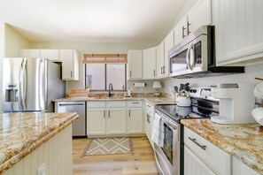 Enjoy cooking in this well-equipped kitchen with a refrigerator, oven, microwave, and dishwasher.