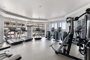 A gym with treadmills, elliptical machines, and weight equipment.