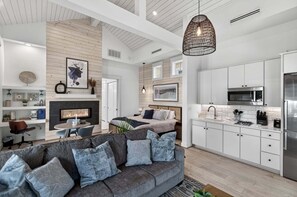 A modern interior with a kitchen, dining area, and living room.