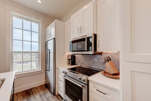 Enjoy cooking in this kitchen with a window offering a view of the outdoors.