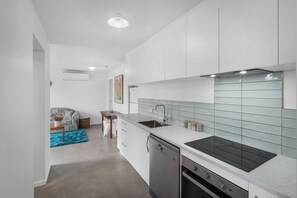 Enjoy cooking in this well-equipped kitchen with a stainless steel sink and induction cooktop.
