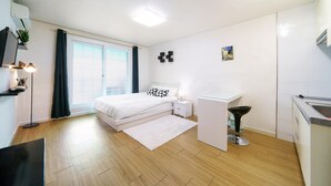 A modern bedroom with a bed, bedside table, and a small desk with a chair. - Gapyeong Oneul-yeogipension (Gapyeong)