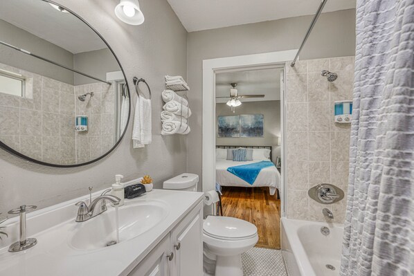 A modern bathroom with a bathtub, toilet, and sink.