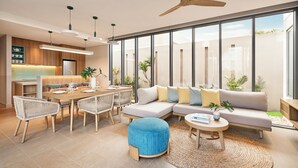 A modern living room with a dining area, large windows, and a ceiling fan. - IXORA Ho Tram By Fusion (Ho Chi Minh City)