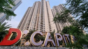 A high-rise building with a prominent 'D.CAPITA' sign in front.