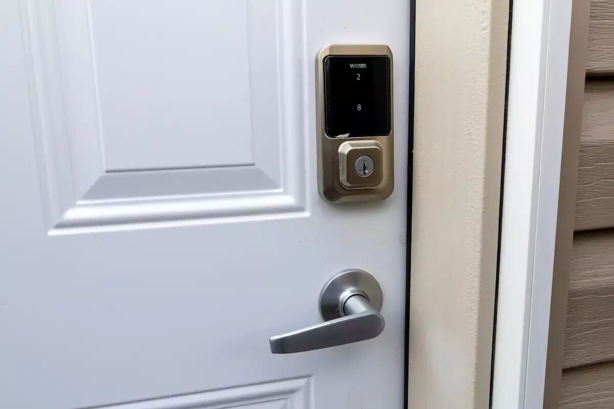 A white door with a digital keypad lock and a lever handle.