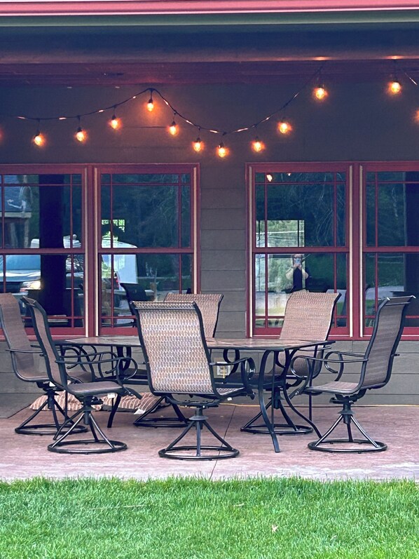 Relax in style with comfortable seating for six, surrounded by a casual outdoor dining area.
