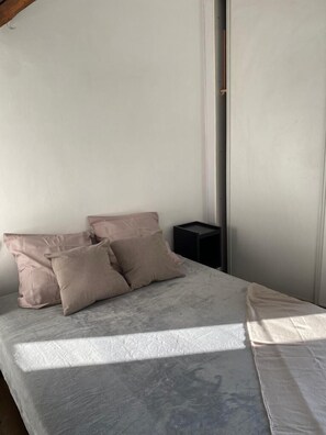 Cozy retreat with a comfortable bed, nightstand, and ample space to unwind.