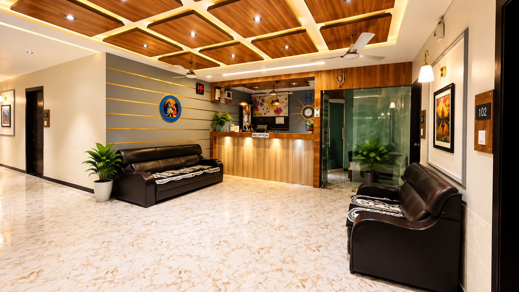 A hotel reception area with a reception desk, a sofa, and a seating area.