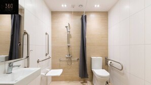 A modern bathroom with a shower, toilet, and sink. - Stylish 1BR Meridian in central St Julians (San Ġiljan)