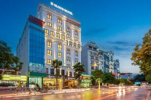 A hotel with a modern facade, multiple floors, and illuminated signage. - Gloud Hotel (Hanoi)