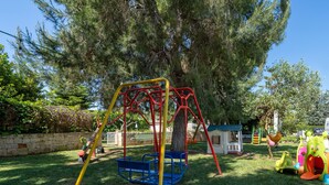 A playground with swings, slides, and climbing structures.