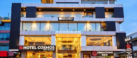 Un hotel con fachada moderna, un lounge al aire libre Skyloft y un bar Vibrations.