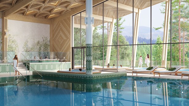 Un área de piscina interior moderna con un amplio ventanal que ofrece vistas a árboles y montañas.