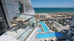 A hotel balcony with a view of the sea, a swimming pool, and a parking area. - Alezzi Infinity Resort & Spa (Navodari)