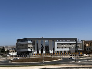 A modern building with a symmetrical facade, large windows, and a central entrance. - SUDRESIDENCE  (Agadir)