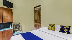 A bedroom with a bed, wooden wardrobe, a television, and a fan. - OYO Homes 91151 Desa Wisata Kreatif Perdamaian Srumbung Gunung (Bawen)