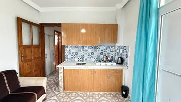 Full-sized fridge, electric kettle, cookware/dishes/utensils