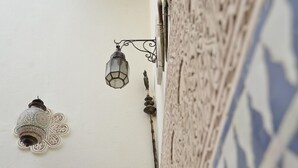 A wall-mounted lantern and a decorative bird figure. - Le Cèdre d'Argent (Fes)