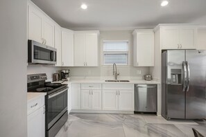 Fridge, microwave, oven, stovetop - Remarkable Superdome Group Home w/Heated Pool, Parking, Patio, 8 Beds & 5 Baths (New Orleans)