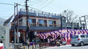 A building with a sign reading "Naini Hill Inn." - Naini Hill Inn (Haldwani)