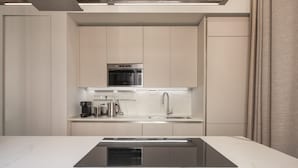 A modern kitchen with a central island, stainless steel appliances, and a marble countertop. - Sant'Ambrogio Luxury Apartment R&R (Milano)