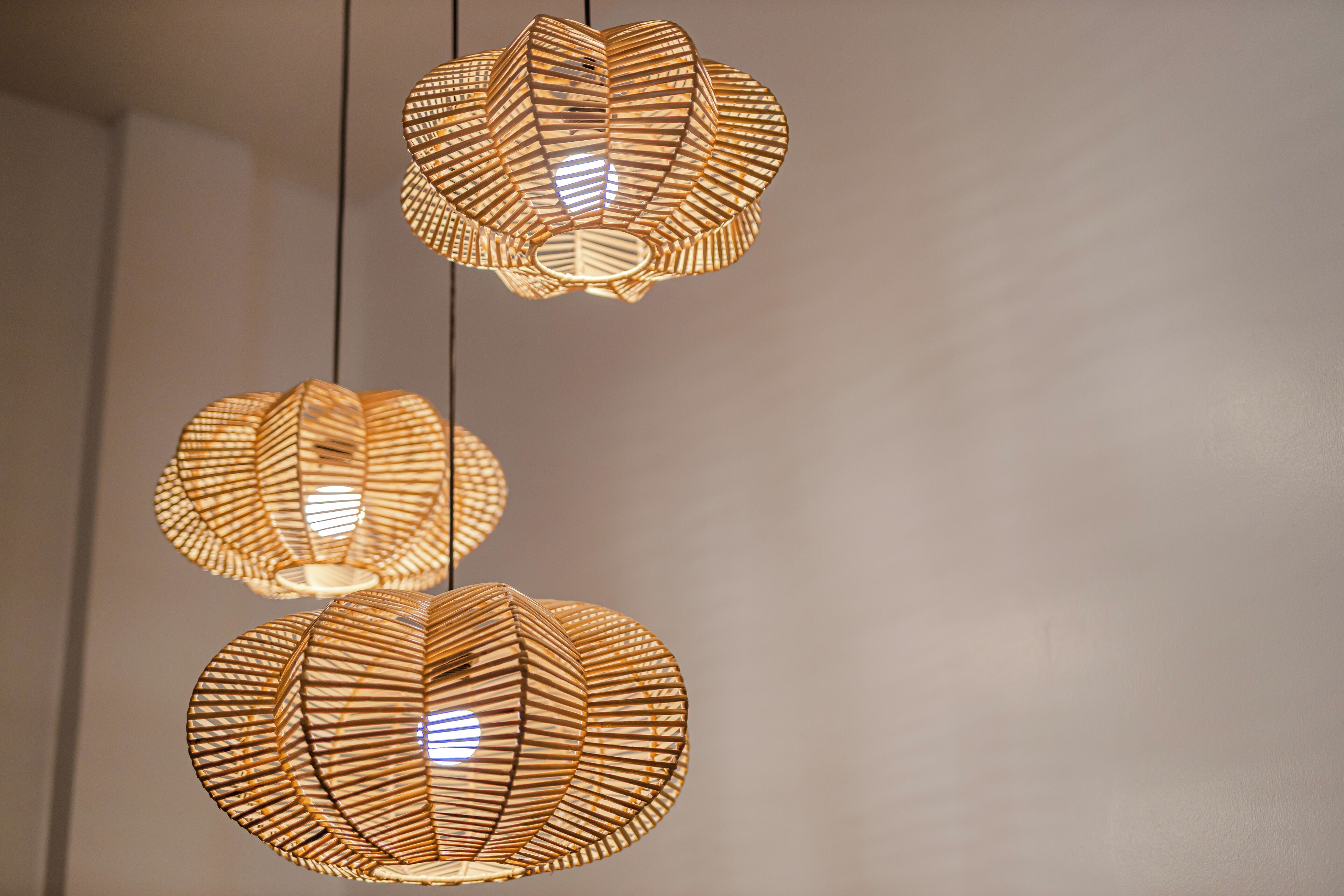 Three hanging pendant lights with a geometric design.