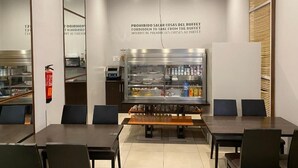 A restaurant interior with a buffet area, tables, chairs, and a fire extinguisher. - dpCristal Calvo Sotelo 164 4C (Sarria)