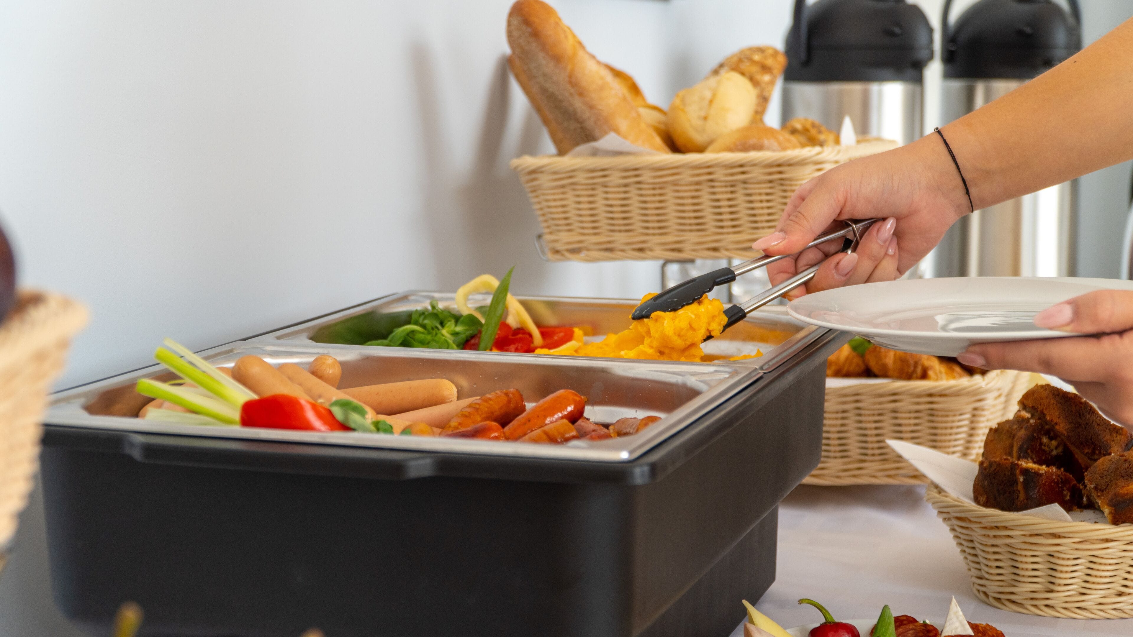 A buffet setup with various food items and baskets.