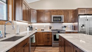 Enjoy cooking in this well-equipped kitchen with a gas stove, microwave, and ample storage.