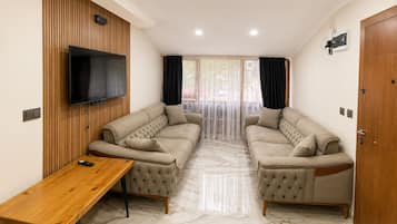 Elite Apartment, 1 Bedroom, Partial Lake View | Living area | 40-inch LED TV with satellite channels